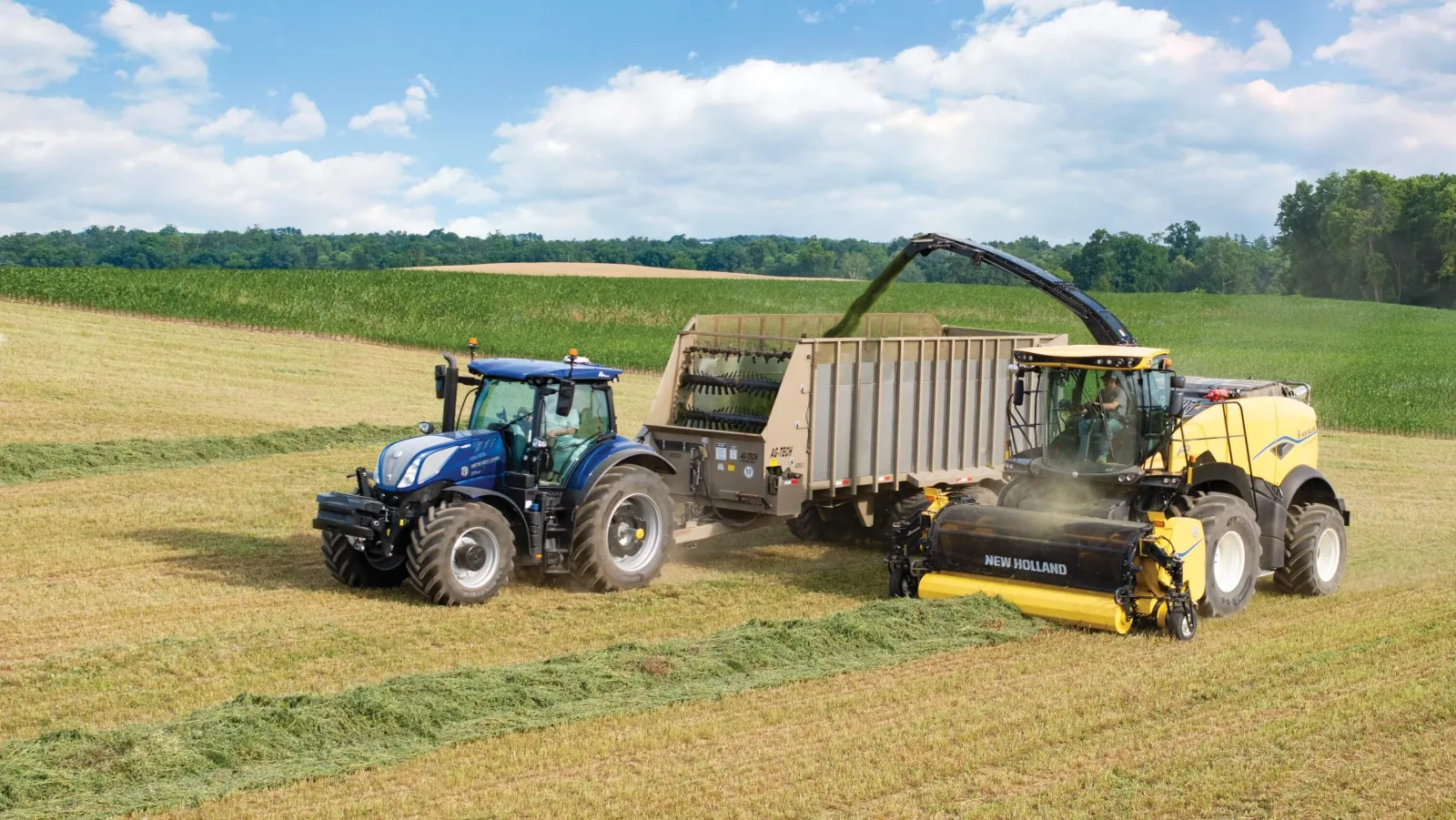 Representative New Holland FR Forage Cruiser harvesting hay beside a tractor and wagon