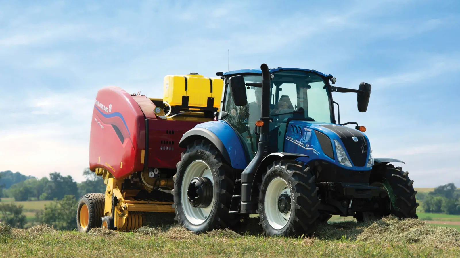 Representative New Holland T5 tractor operating a round baler