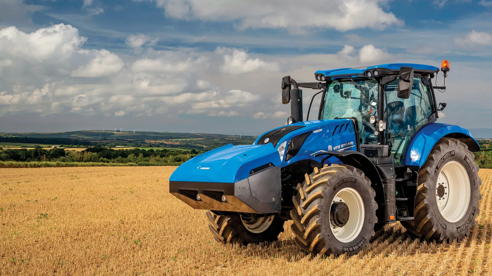 Representative New Holland T6 Methane Power tractor in a harvested field