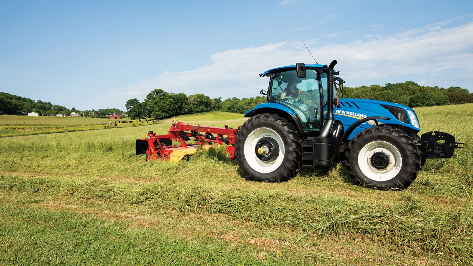 Representative New Holland T6 tractor mowing hay
