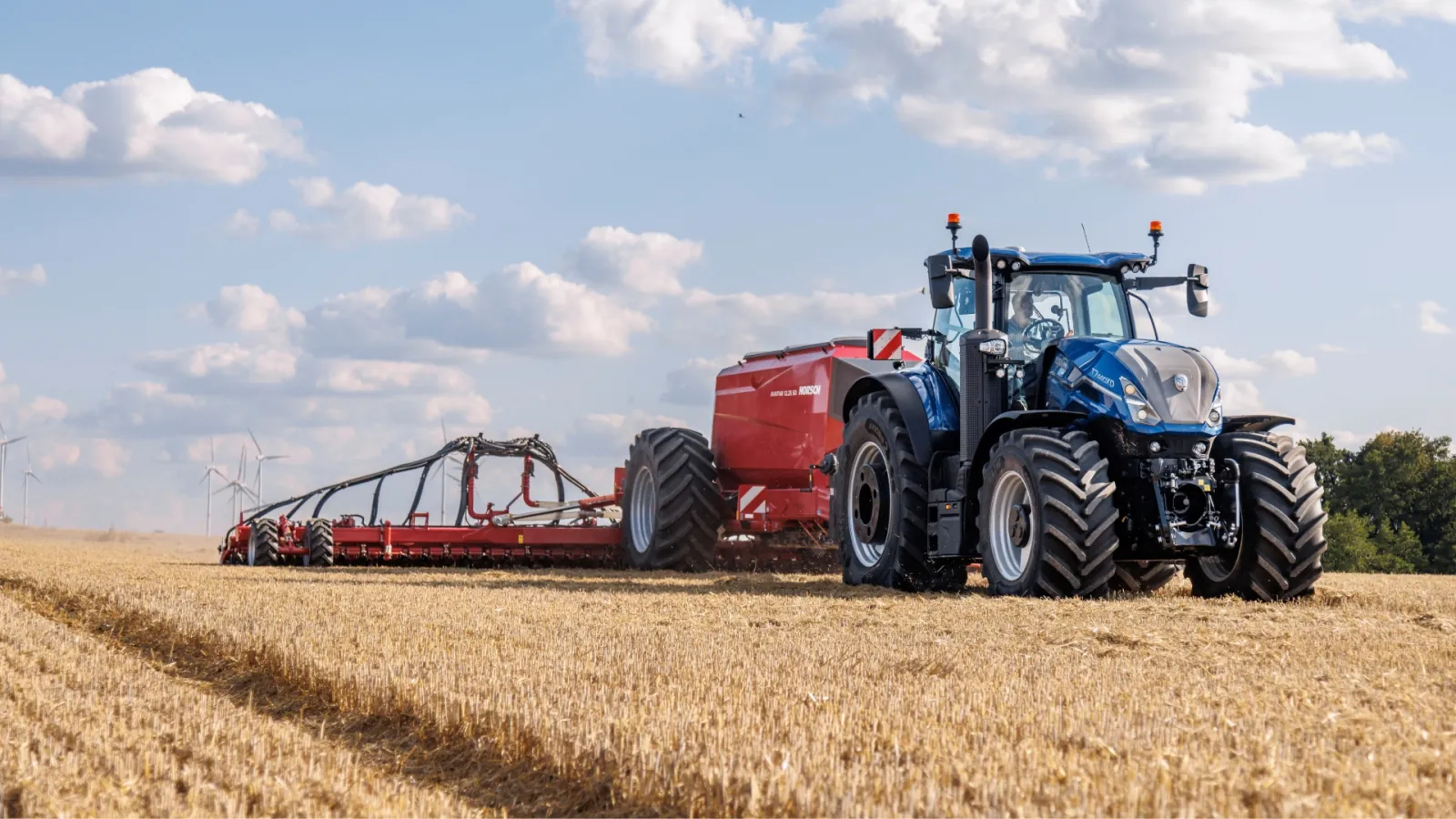 Representative New Holland T7 tractor pulling tillage equipment