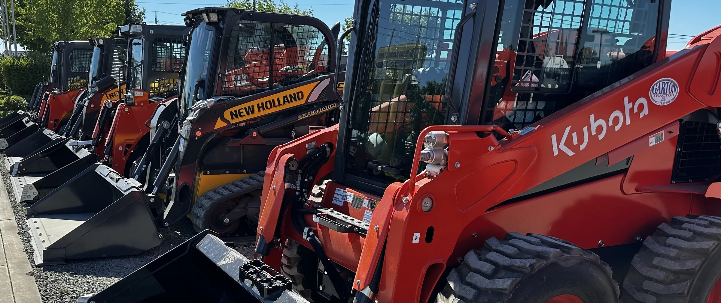 New Holland and Kubota compact equipment lined up at Garton Tractor