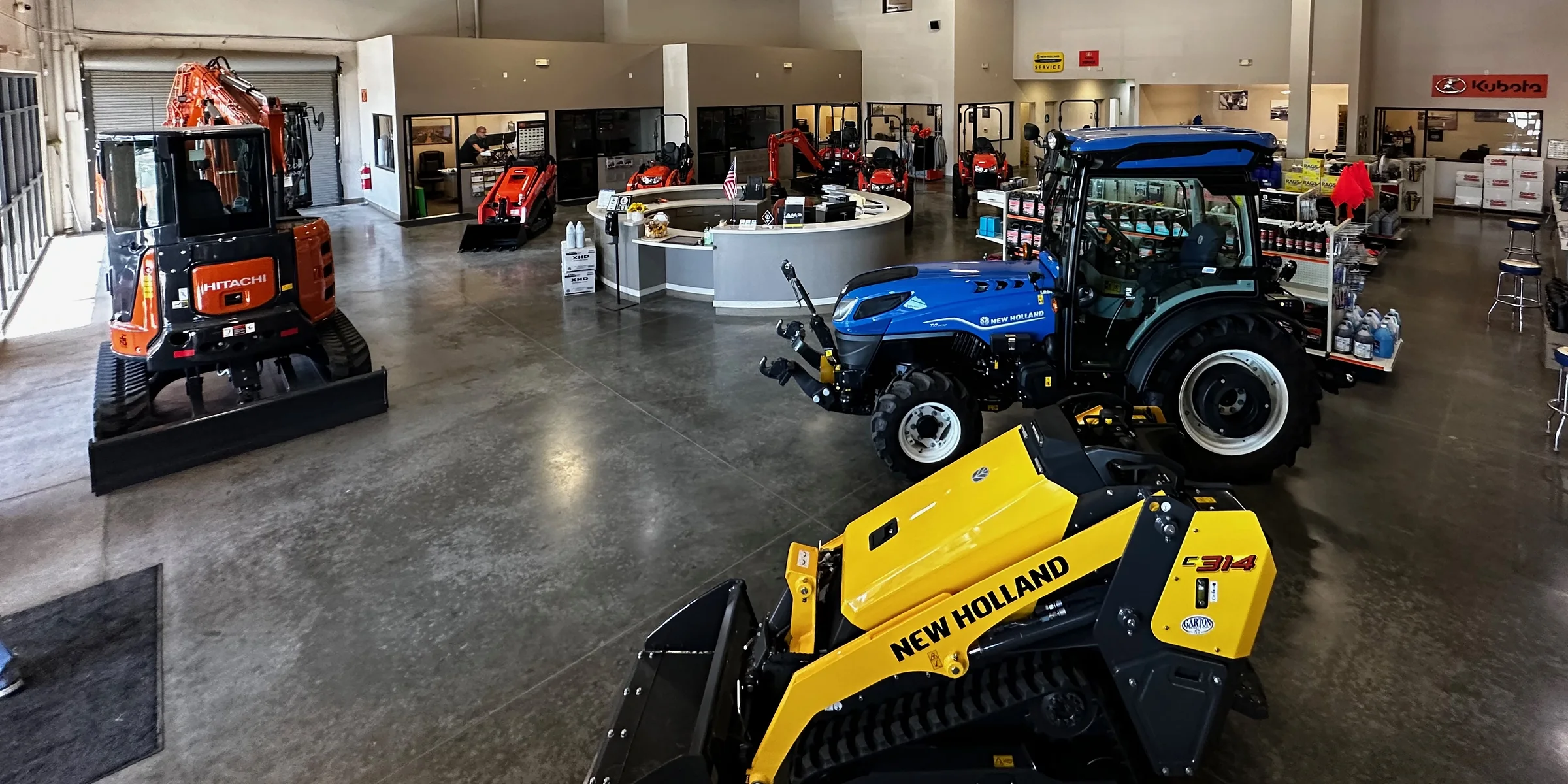 Garton Tractor showroom with Hitachi, Kubota, and New Holland equipment